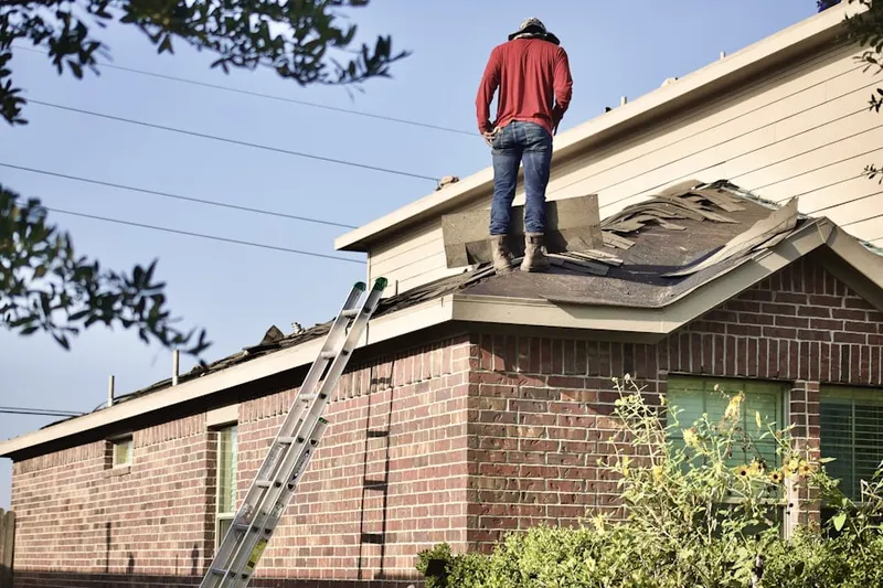 Professional roofer working on a residential roof in Oronoque Hills North